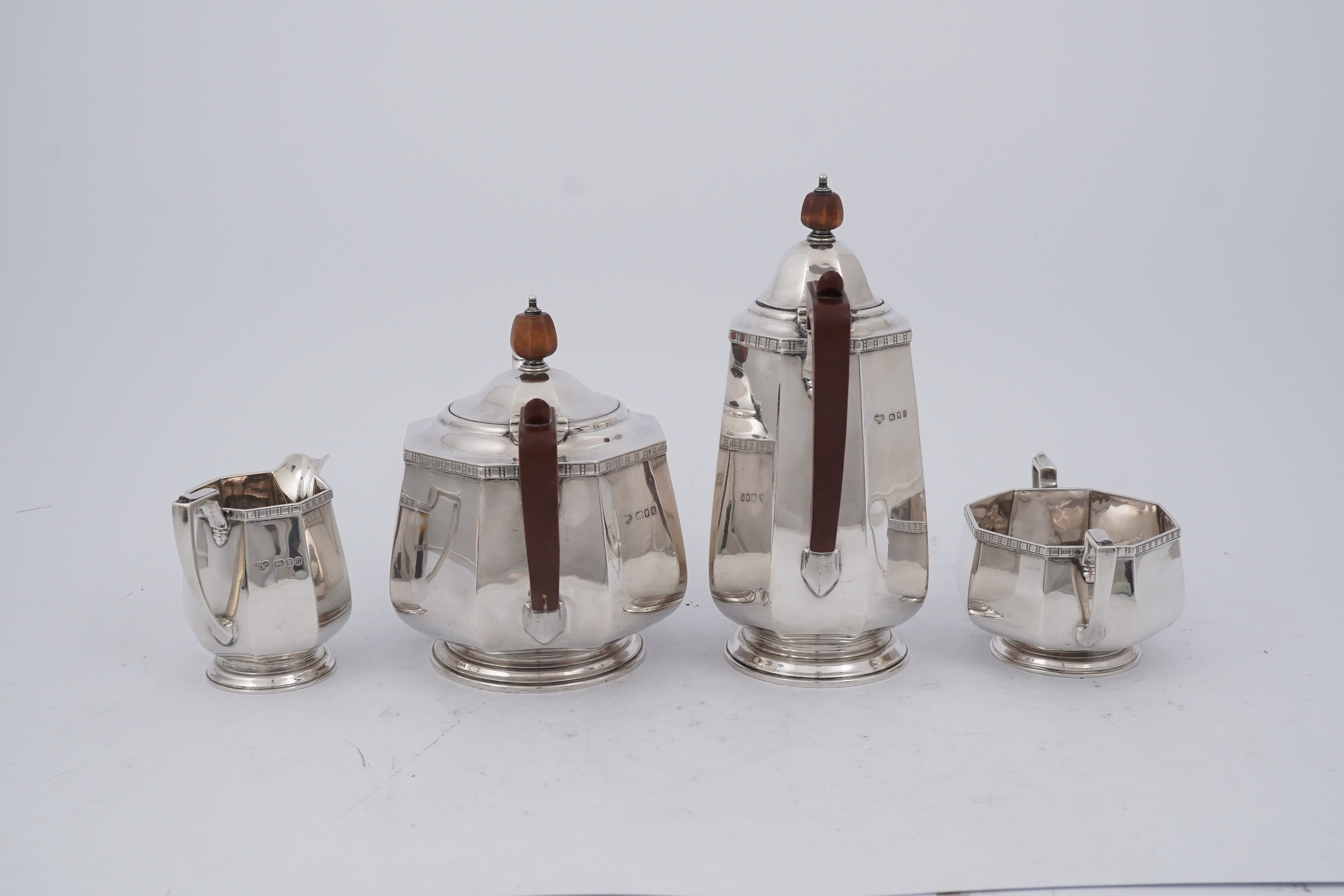 A George V silver four piece octagonal tea set by Goldsmiths & Silversmiths Co Ltd